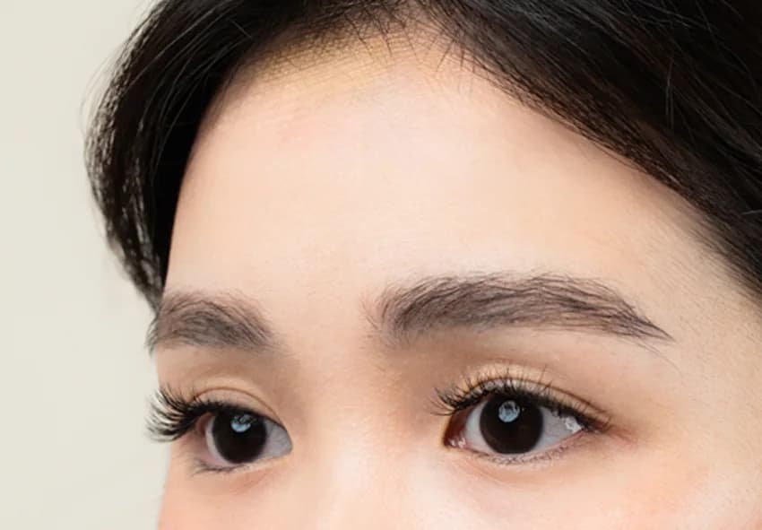 POMÉ client wearing Eyelash Triple (3D) with Brow Sculpt and Tint