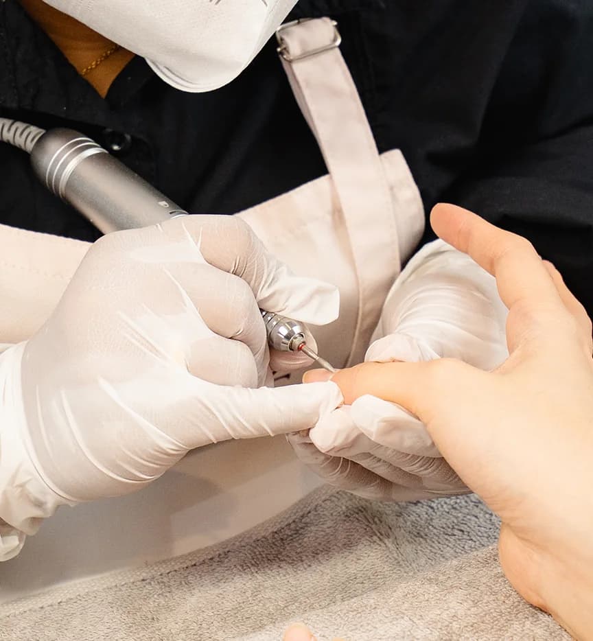 A POMÉ nail technician performing a Russian manicure